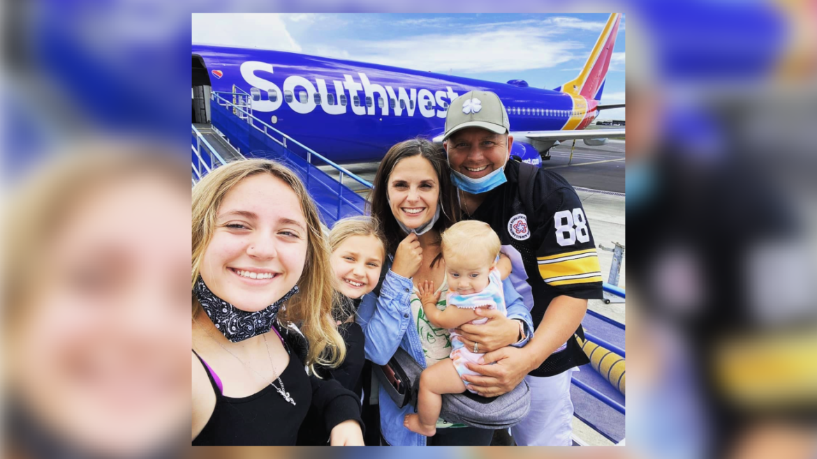 curtin family in front of a plane